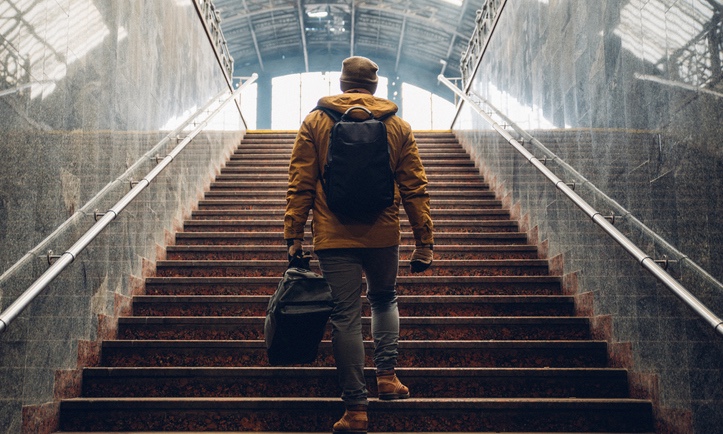 Man_going_up_steps_with_luggage_edited